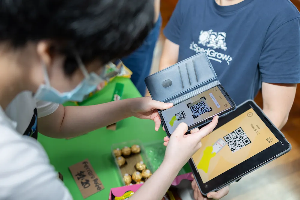 A participant scanned a QR code during a simulation, practising cashless payment skills using the Budding Life app