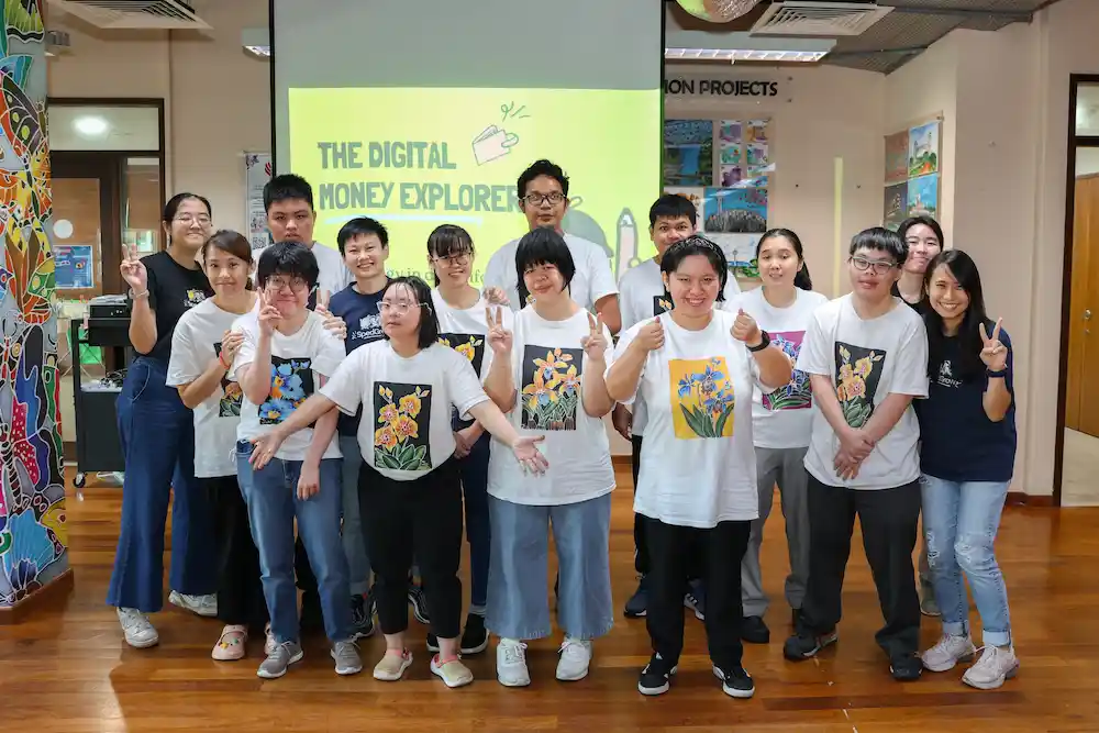 Participants and trainers celebrate the completion of a workshop focused on building digital skills for greater independence