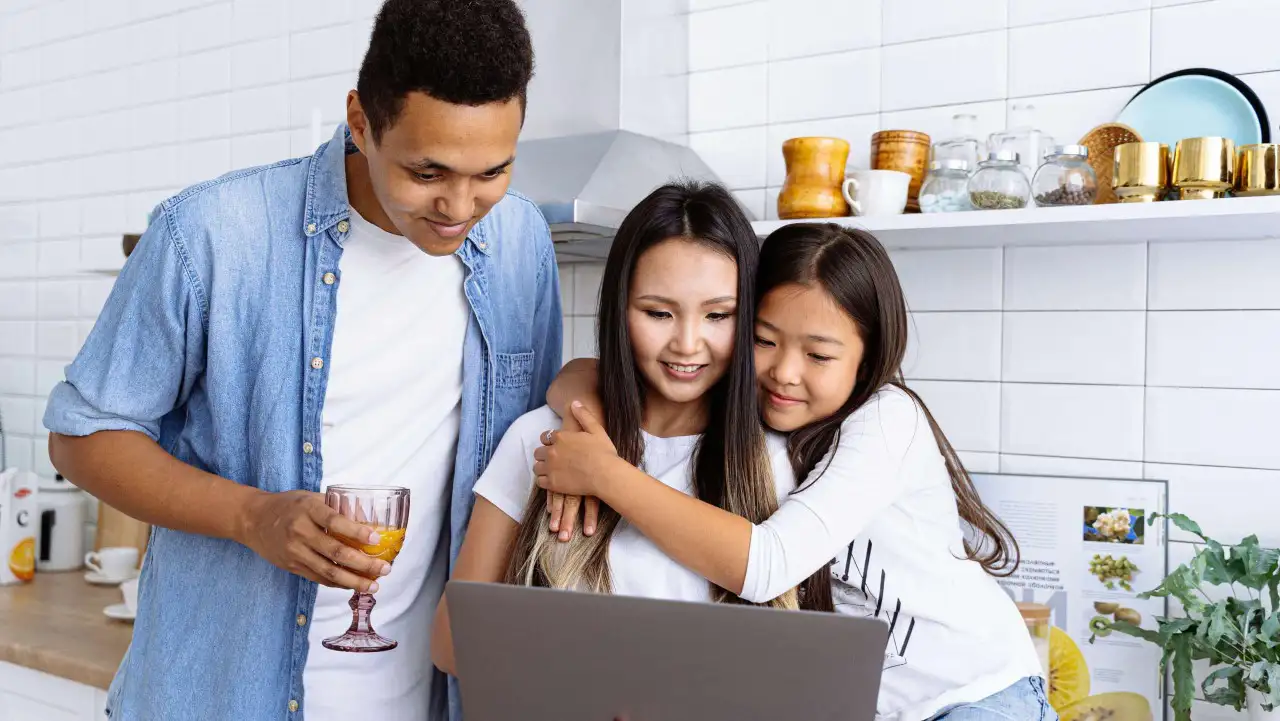 A family interacting with a laptop