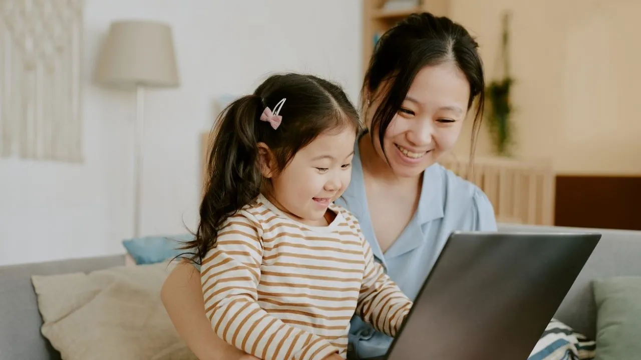 parent and child using laptop