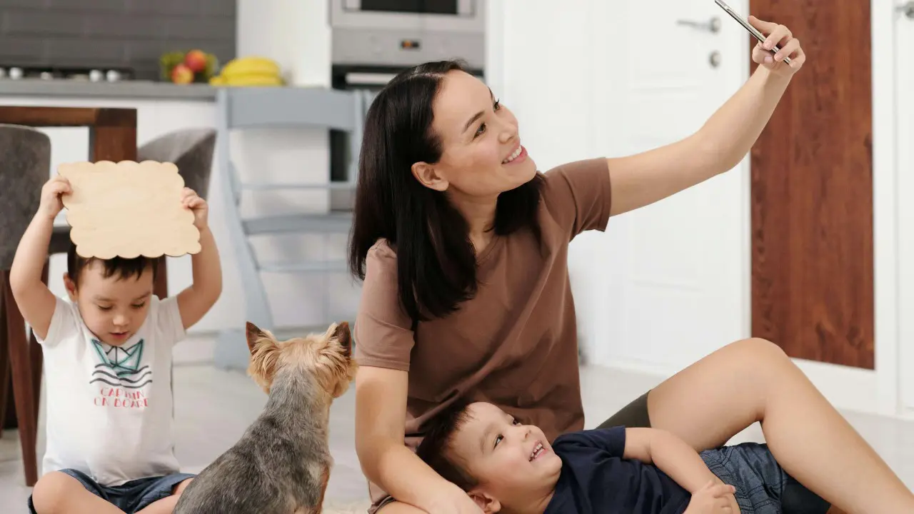 A young mum taking selfies with her children.