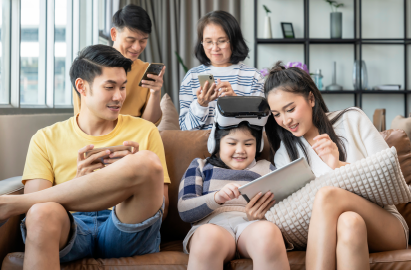 Parents with young children learning and enjoying digital technology together