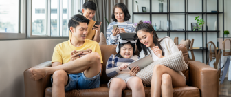 Parents with young children learning and enjoying digital technology together