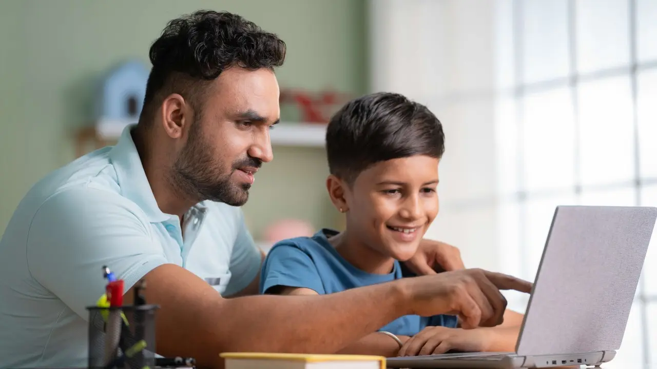 father and son using a laptop